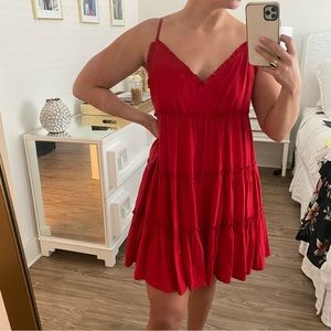 Red tiered sundress with bow back and ruffled details